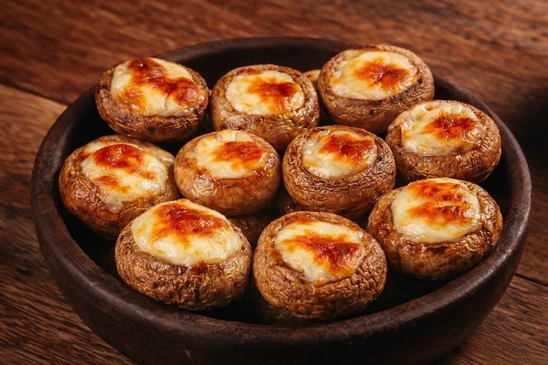 Stuffed mushrooms in a rustic bowl.webp